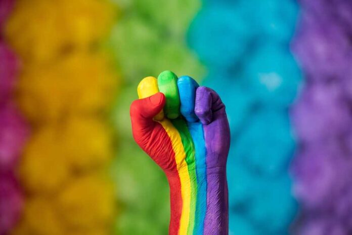 Rainbow,Colors,Painted,Hand,Raised,Making,Fist,,Sign.,Rainbow,Colors
