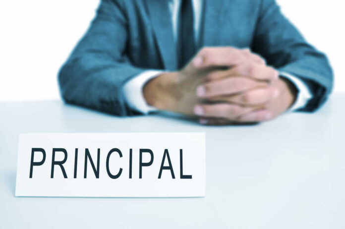 A,Man,Wearing,A,Suit,Sitting,In,A,Desk,With