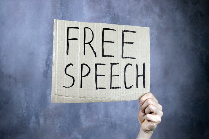 Hand,Holds,A,Banner,With,The,Inscription,Free,Speech,,Censorship