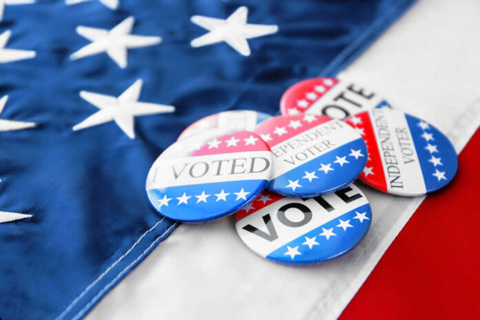 American,Vote,Badges,On,National,Flag,Background