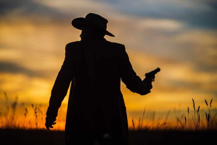 Silhouette,Of,A,Cowboy,In,A,Hat,With,A,Revolver