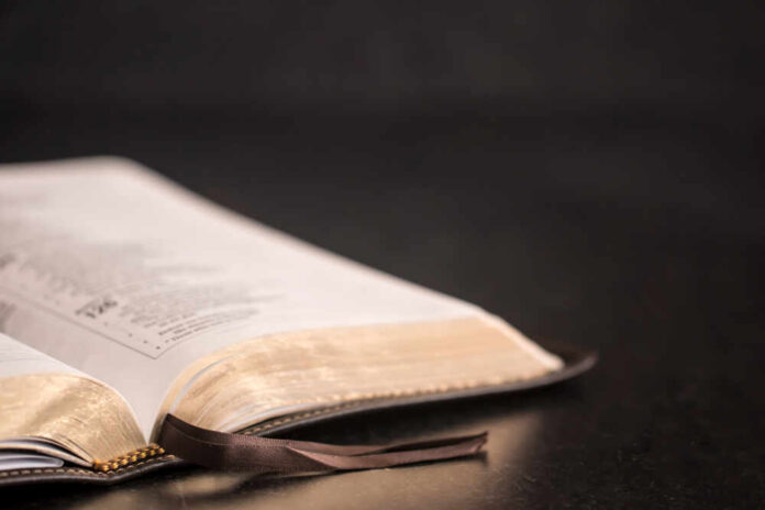 Open,Bible,On,A,Slate,Tabletop,With,Customizable,Space,To